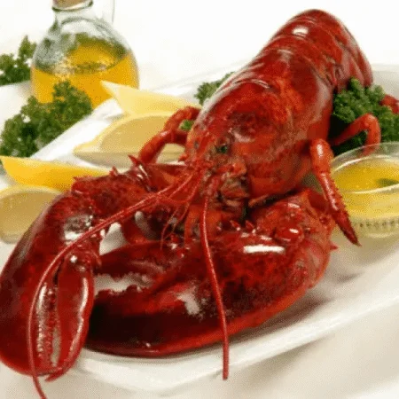 cooked lobster served with butter and lemon